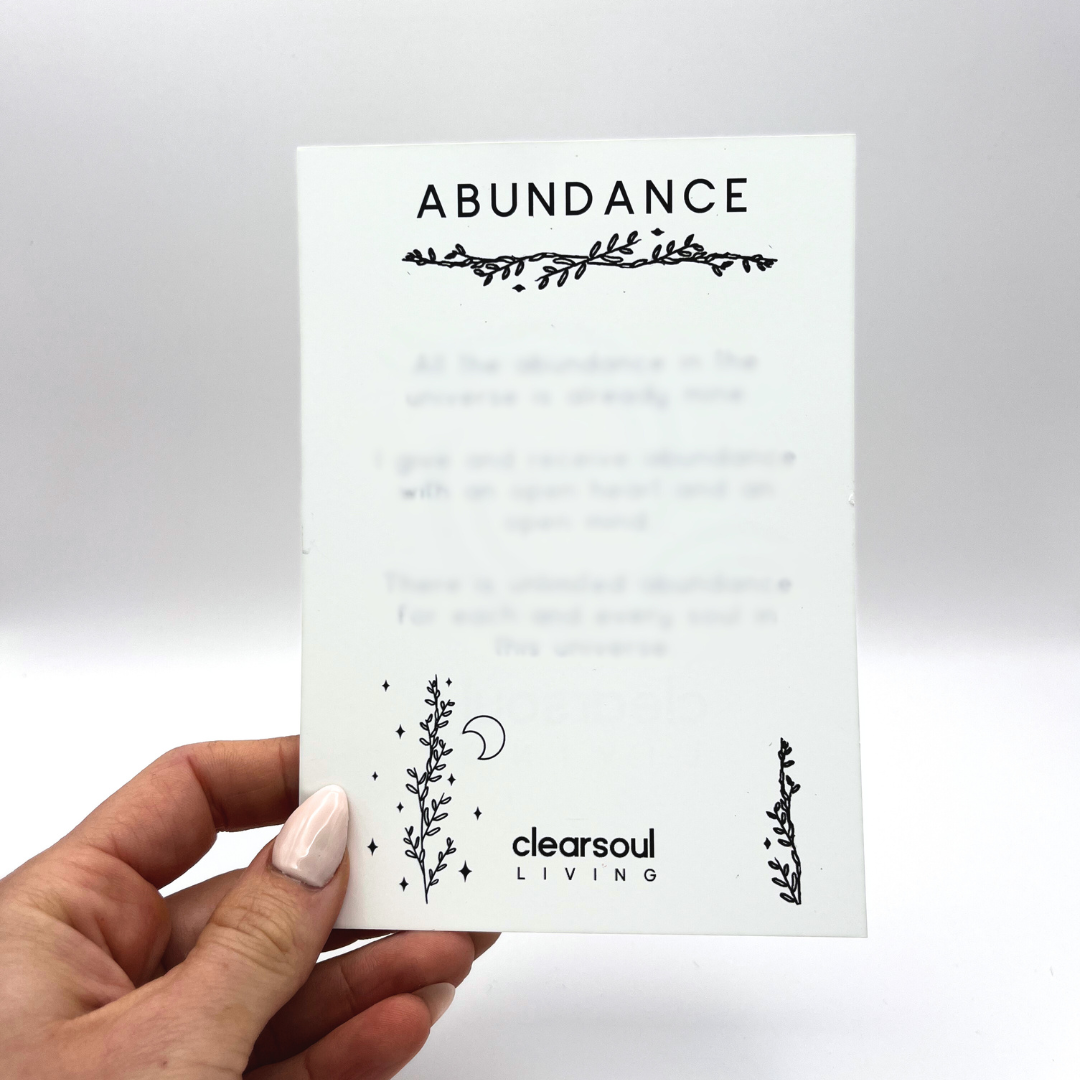 Clear Soul Living Abundance affirmation card featuring positive statements to attract prosperity and energetic flow.
