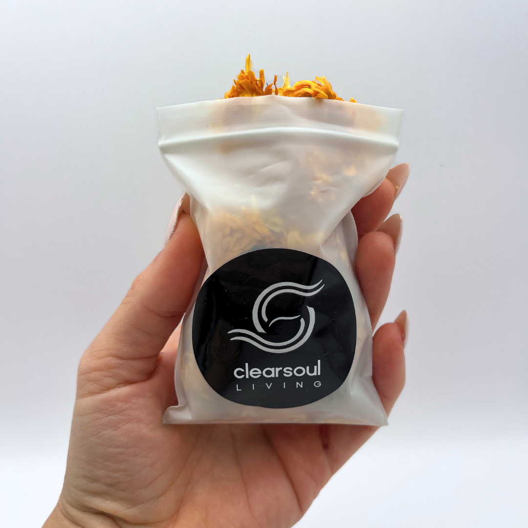 Clear Soul Living pouch filled with dried calendula flowers, known for their uplifting energy and support in emotional healing.