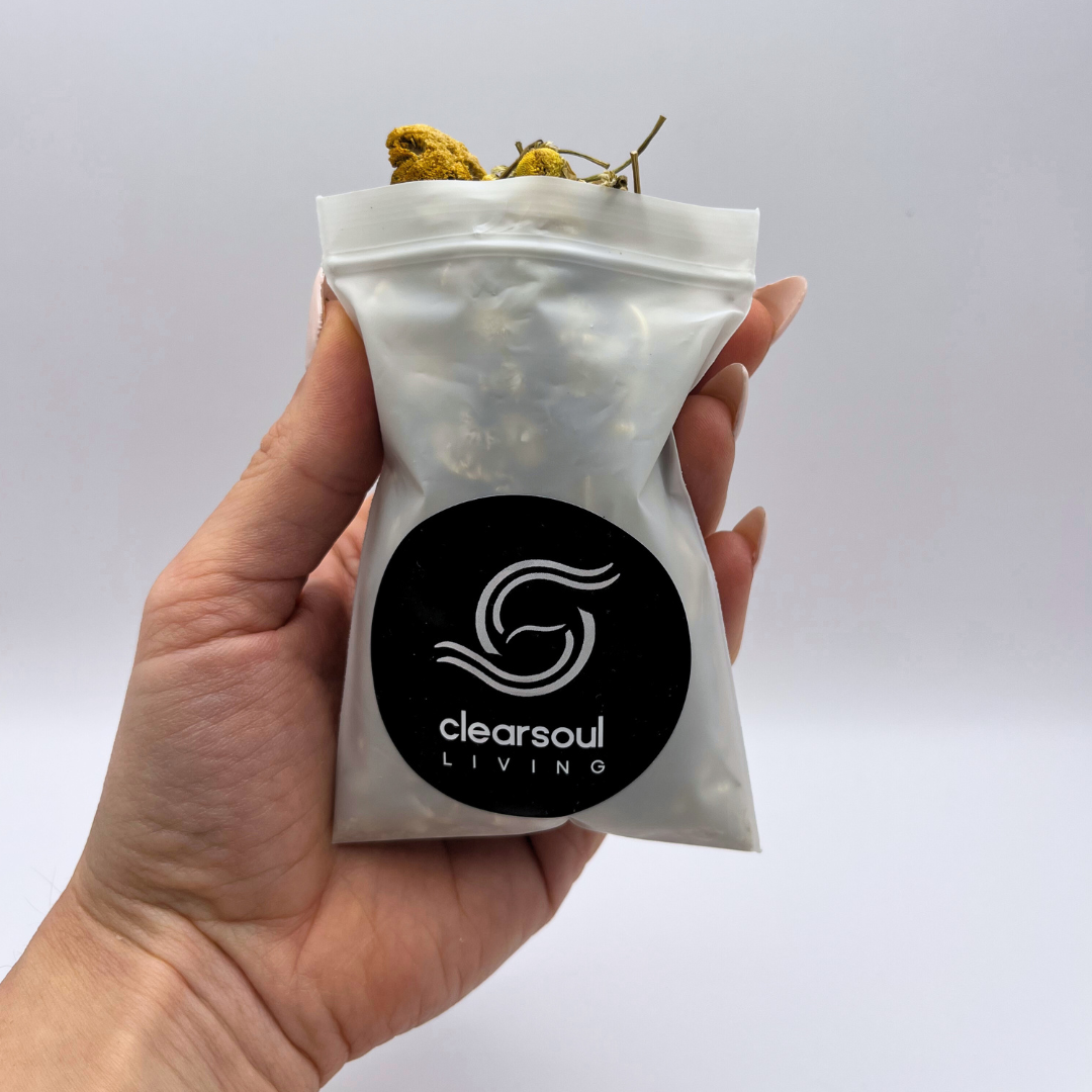 Clear Soul Living pouch filled with dried chamomile flowers, known for their soothing properties and emotional relaxation.