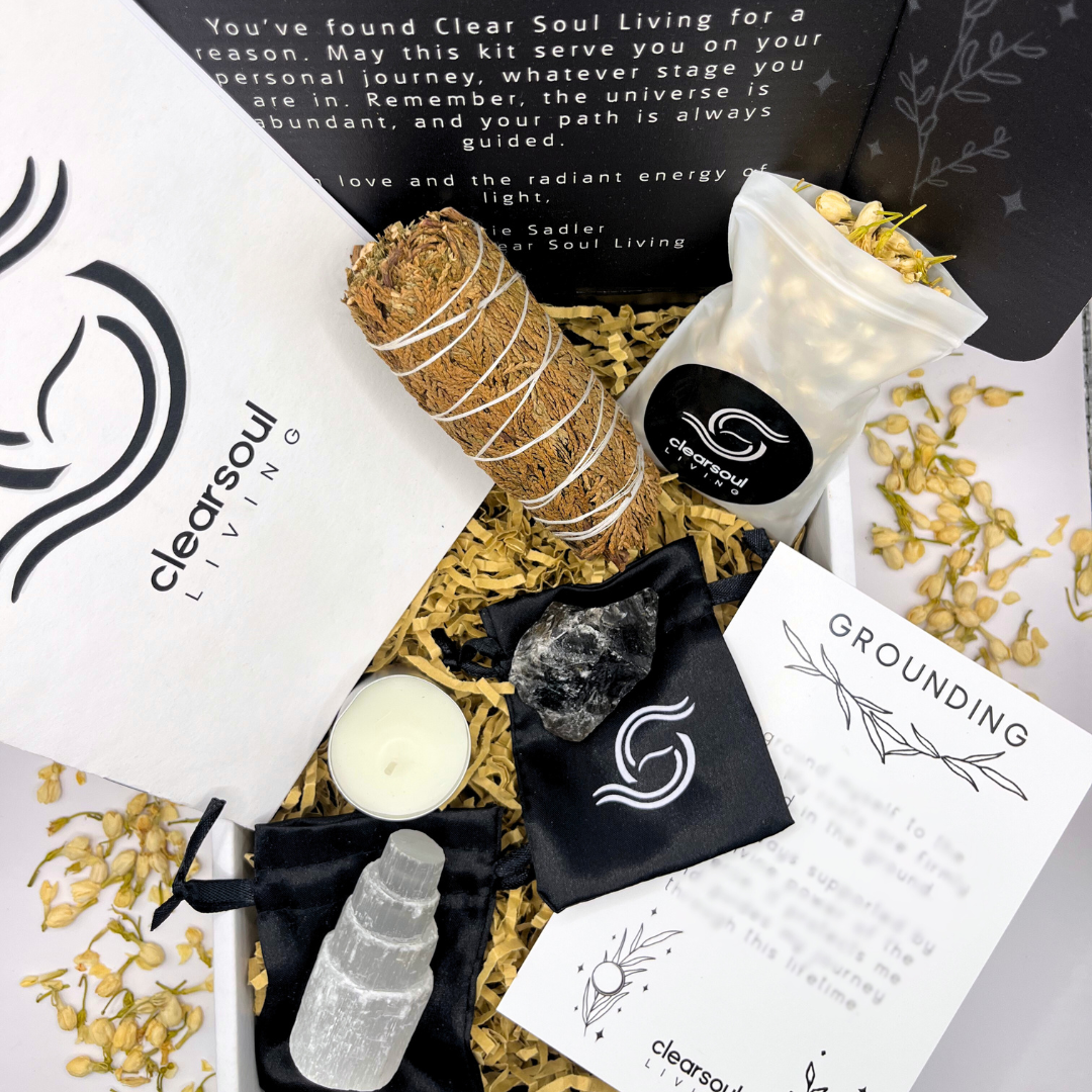 Grounding Kit with Smokey Quartz, Selenite Tower, Cedar Smudge Stick and calming botanicals. Designed to release stress and realign your energy. Clear Soul Living packaging.